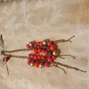 Women's gold tone necklace with gold and pink varying size beads. Used.